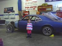 My husbands project car and our daughter.  I took this pic because the car will stay the same and my daughter will be much bigger lol.