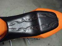 Ostrich seat with orange tribal flame stitching
